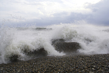 Sea, waves are breaking on stones, seashore