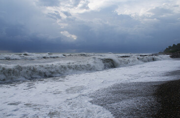 Fototapeta na wymiar Storm, strong waves, sea coast, pebbles on the beach
