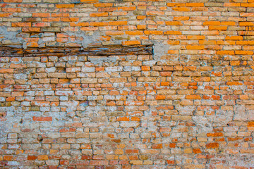 eroded brick wall with wood