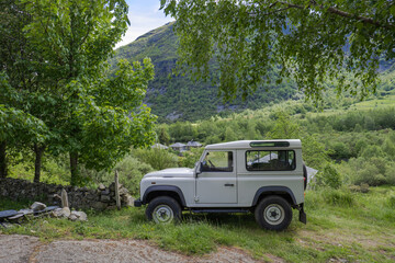 rural tourism with the 4x4 car between high mountains and green north in summer.