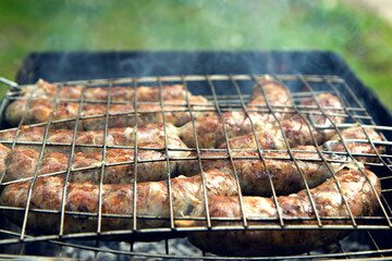 homemade sausages grilled on a barbecue closeup.