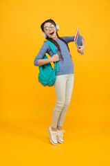 Girl loves music. Happy child listen to music yellow background. Little kid wear headphones playing music. Music school and education. New technology. Modern life. Stay wild and free