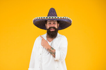 mexican day of the dead. national mexico holiday. mexican hat sombrero and mustache. Enjoying summer. man in festive mood pointing finger. 5th of may. brutal bearded man in mexican sombrero hat