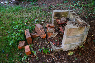 a self-made brick smokehouse standing in the yard of a country house