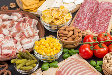 Ingredients for cooking breakfast: bacon corn tomatoes basil.