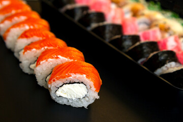 Large set of Delicious sushi rolls. A lot assortment Philadelphia roll Dishes from Japanese raw fish. Japan food menu service