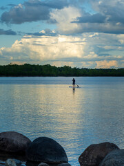 Fototapeta premium Paddleboarder on calm lake