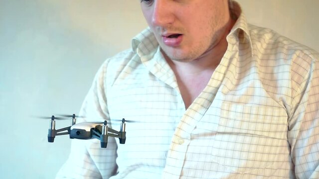 hobbies and entertainment.small four-engine drone flies indoors