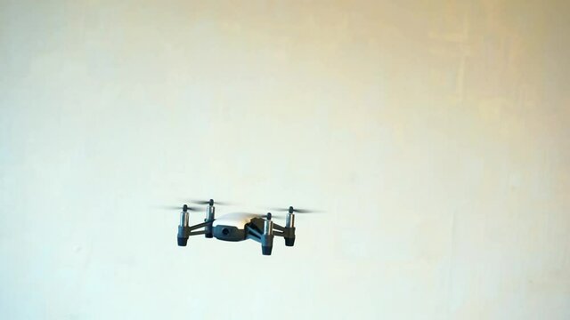 hobbies and entertainment.small four-engine drone flies indoors