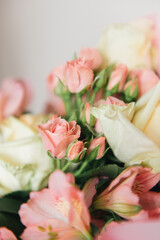 Fototapeta na wymiar Beautiful delicate pink flower bouquet of white roses and eustoma in a beautiful package