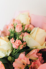 Beautiful delicate pink flower bouquet of white roses and eustoma in a beautiful package