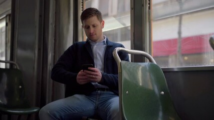 MS Businessman standing in cable car and using smart phone / Milano, Milano, Italy