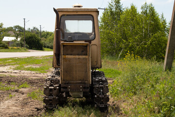 old working tractor stands on a field in Ukraine to dig up land