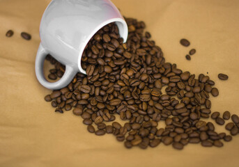 coffee beans sprinkled out of a cup