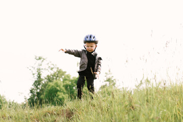 Happy little boy riding a bike running in the Park