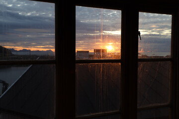 View of sunrise through the house window.Norway