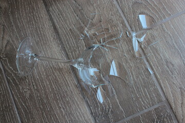 A broken glass tumbler fell to the floor.