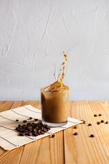 Splashing coffee with milk in a glass