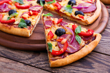 Delicious pizza served on wooden table