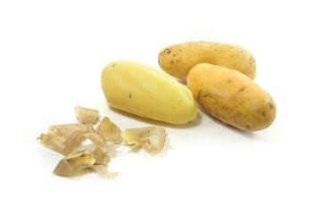 Three young potatoes boiled in their skins, one of them peeled, isolated on a white background,...