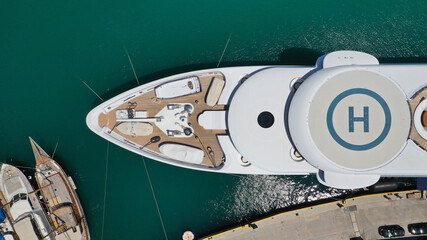 Aerial drone top down photo of luxury yacht anchored in Mediterranean bay marina