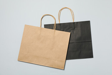 Empty paper bags on gray background, space for text