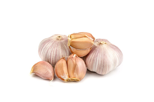 fresh garlic in heads and divided into teeth on a white isolated background