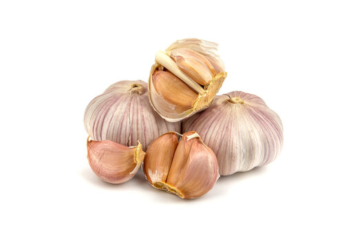 fresh garlic in heads and divided into teeth on a white isolated background