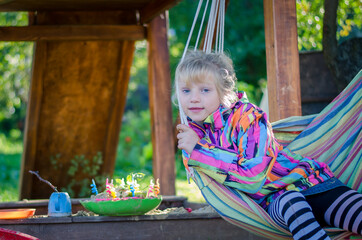 little child playing in sandbox in playground