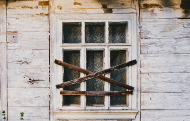 Boarded-up window in an abandoned old building.