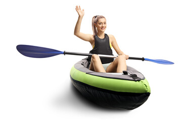 Woman kayaking and waving at the camera