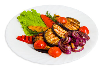 Vegetable salad on white plate with grilled eggplant, cherry tomatoes, red and yellow bell peppers, purple onions, dill, lettuce leaf.