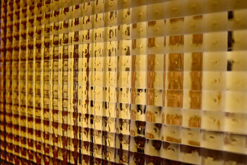 abstract golden background with small transparent squares of glass  from a vintage door - geometric wallpaper