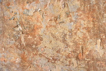 aged vintage surface of a wall with broken abstract texture and saturated orange color in the  background - damaged wallpaper 