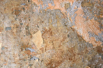 aged decay surface of a wall with broken abstract texture and orange salmon color in the  background - damaged wallpaper 