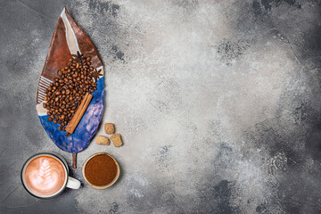 Top view of a Cup of coffee, cappuccino on a table with coffee beans with a wooden spoon