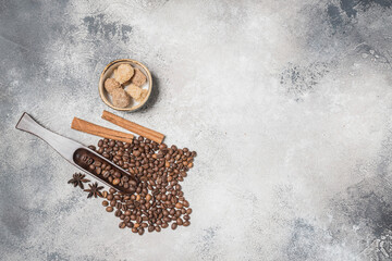 Coffee beans with a wooden spoon and cinnamon sticks