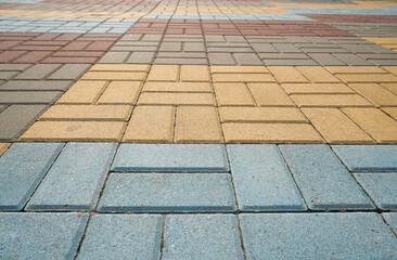 Stone pavement in perspective. Stone pavement texture. Granite cobblestoned pavement background. Multicolored brick stone background