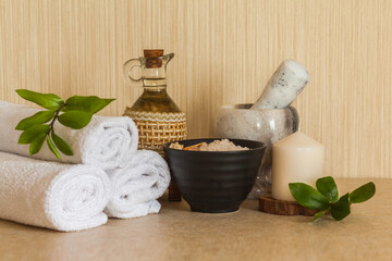 Obraz na płótnie Canvas Spa, beauty and wellness background. Towel, cosmetic massage oil, fresh leaf, sea salt with shells and candle