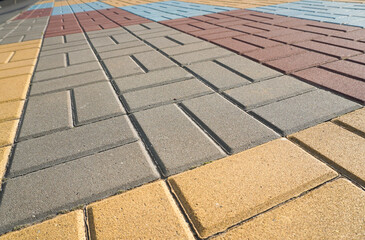 Stone pavement in perspective. Stone pavement texture. Granite cobblestoned pavement background. Multicolored brick stone background