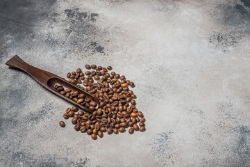 Coffee beans with a wooden spoon and cinnamon sticks