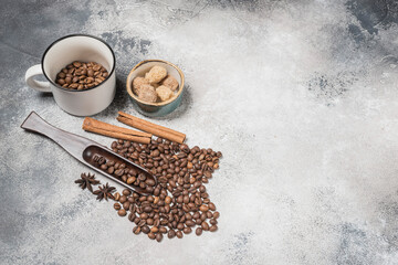 Coffee beans with a wooden spoon and cinnamon sticks