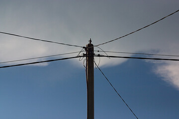 pole with wires on a background of the summer sky