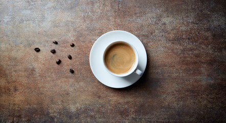 Cup of coffee on rustic stone background. Top view. Copy space.
