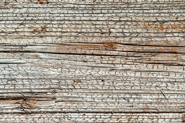 Closeup of texture of an old wooden cracked wall. cracks in natural materials for construction.