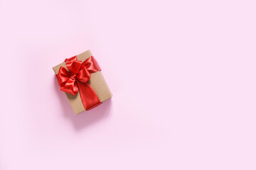 Beautiful composition with gifts with red ribbons on a pink background. Box with presents. Top view.