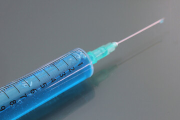 Syringe filled with needle guard isolated. Medical supplies for vaccination and injection.