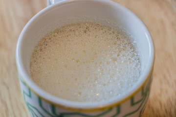 Close Up of Hot Milk Cup on Wooden Plate