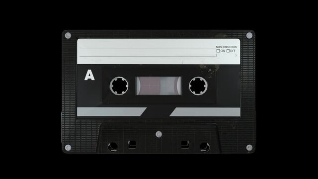Vintage audio cassette tape playing on a black background