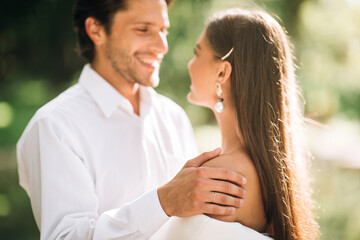 Happy Newlyweds Looking At Each Other During Outdoor Marriage Ceremony